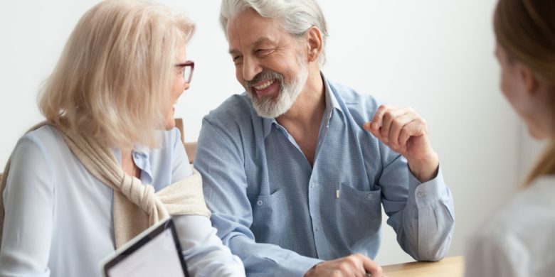 senior couple happy to talk to agent who is offering final expense insurance