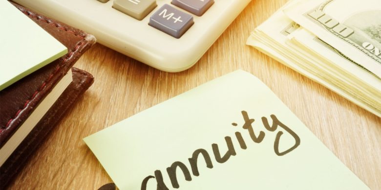 annuity written in post it note next to cash and calculator