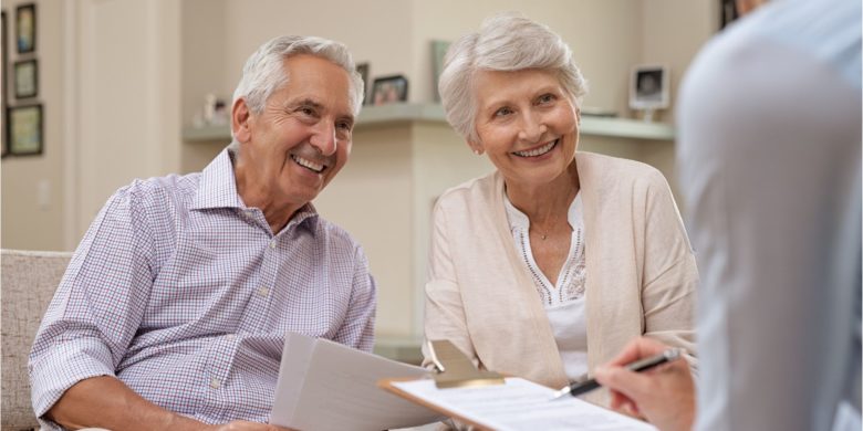 senior couple talking to agent to purchase permanent life insurance