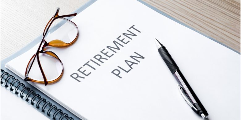 retirement plan under glasses and pen