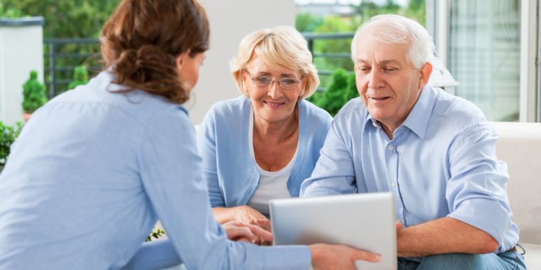 senior couple doing a life insurance policy review with the help of an agent